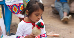 Huichol girl with a ceremonial rattle