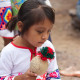 Huichol girl with a ceremonial rattle