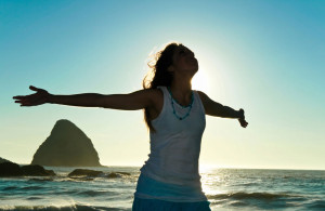 Woman embracing the healing energy of the ocean.