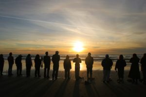 A sunset ceremony alongside the pacific ocean
