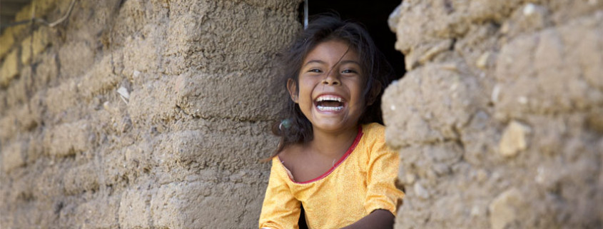 Huichol Girl Laughing in hut window